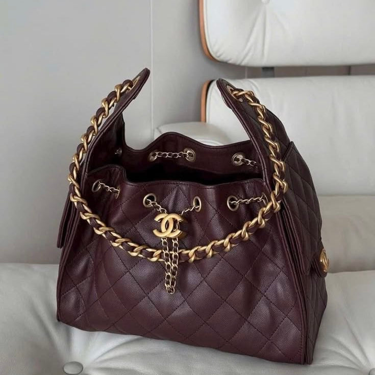 Chanel 25 Small Handbag in a quilted burgundy or deep plum brown grained caviar leather with gold-tone hardware