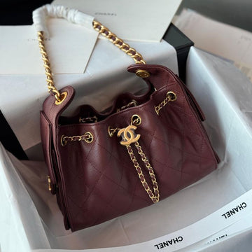 Chanel 25 Small Handbag in a quilted burgundy or deep plum brown grained caviar leather with gold-tone hardware