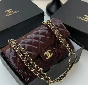 Chanel Classic Flap Bag in a glossy burgundy patent leather with gold-tone