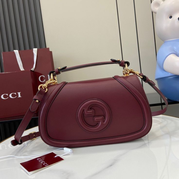 Gucci Blondie Medium Top Handle Bag in burgundy (Rosso Ancora) leather.