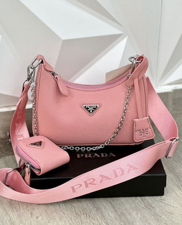 pink Prada Re-Edition shoulder bag, which resembles the Prada Re-Edition 2005 style.