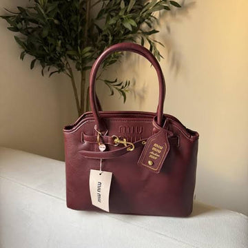 Miu Miu Aventure Nappa Leather Top-Handle Bag in the Amaranth Red (burgundy) colorway